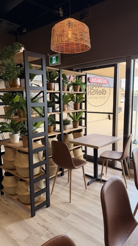 Wish Delish Cafe-Bistro seating area near the entrance with plant shelving