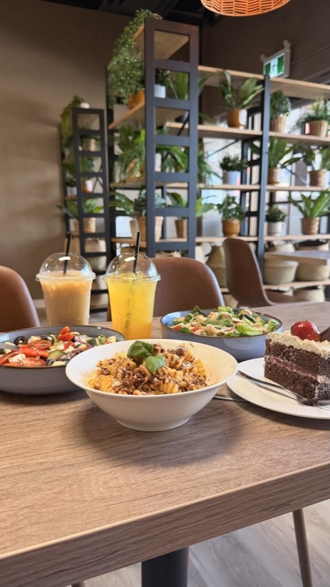 Greek salad, fresh juice, meat sauce fusilli pasta and chocolate cake at Wish Delish
