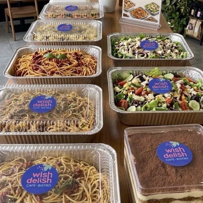 Catering trays with spaghetti, salad and tiramisu from Wish Delish Cafe-Bistro